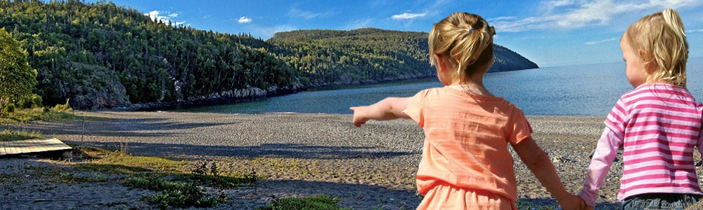 Schreiber Two young girls pointing out at a lake view
